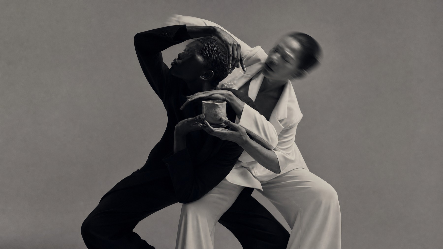 Two dancers in contrasting black and white hold one another in a dynamic editorial portrait about technology and irreducibly human connection.